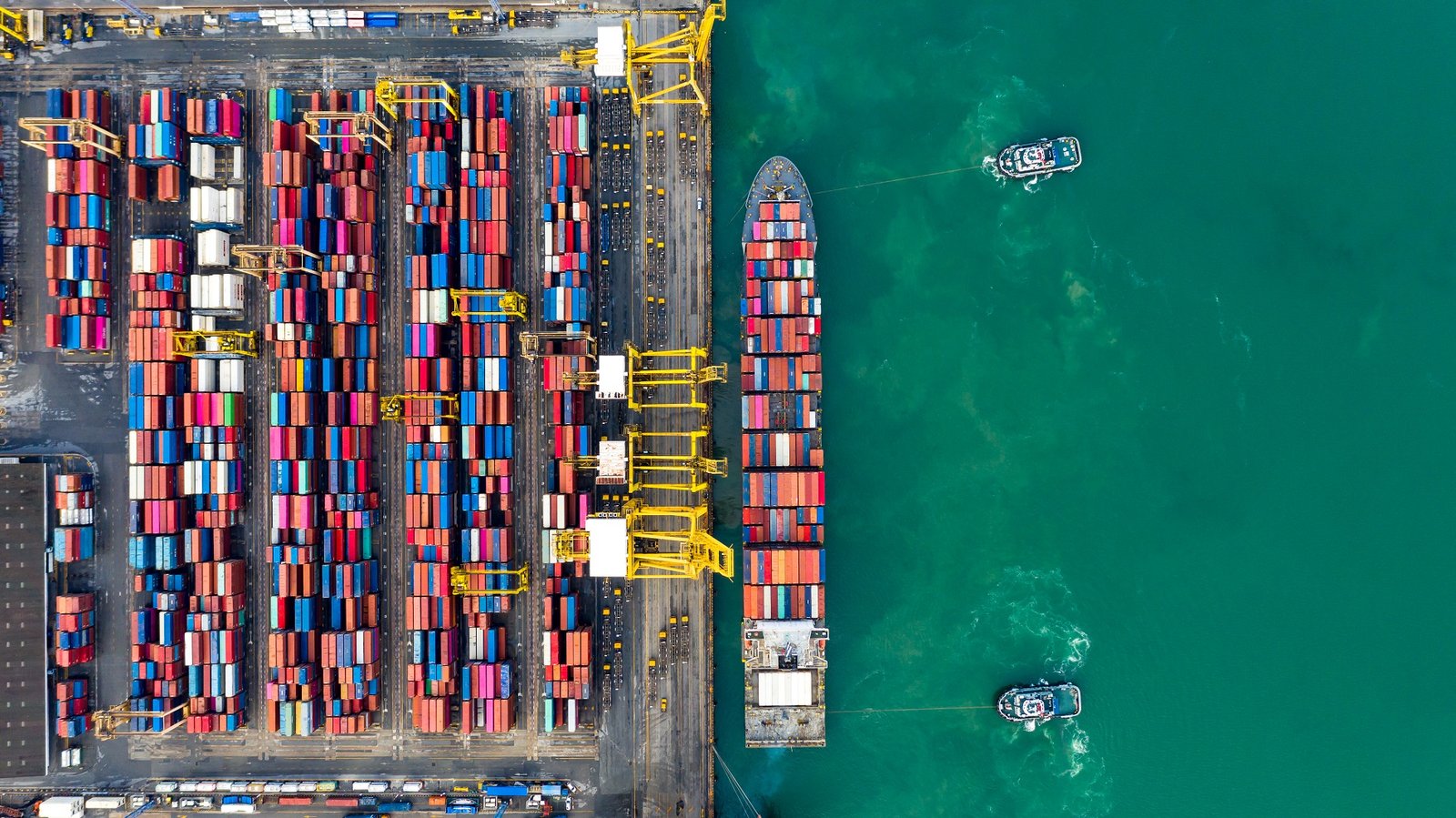 Aerial view tugboats assisting container ship to international commercial dock, Global business import export logistic and transportation company, Commercial dock container cargo vessel freight shipping worldwide.